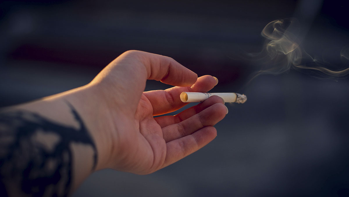 Spliff Definition &ndash; What Is a Spliff? A tattooed hand holding a cigarette