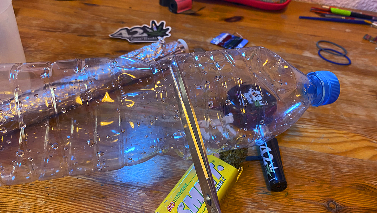 To make a gravity bong, cut the upper part of a plastic bottle.