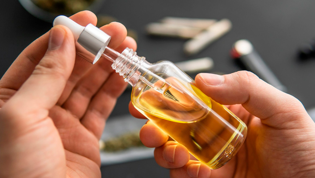 Kosher Cannabis Becomes a Reality: A person's hands handling a bottle with medical-grade cannabis oil