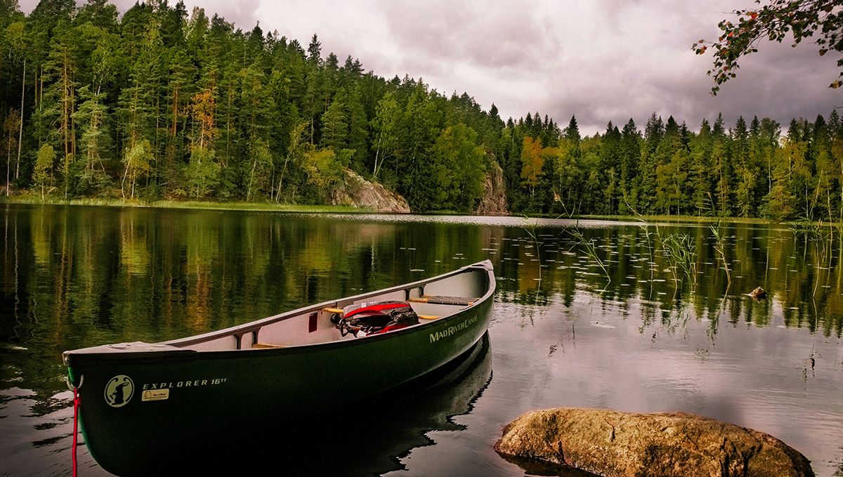 Weed in Finland: Cannabis Legal Status Guide: A lake with a boat and a forest in the background